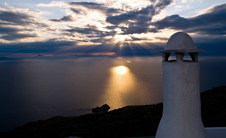 tower part of 'Manalis Winery' background with sea and the sunset